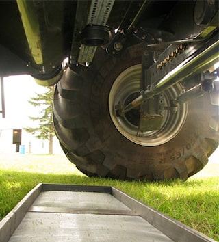 a drop pan underneath a combine highlighting the reason to use the harvest loss calculator